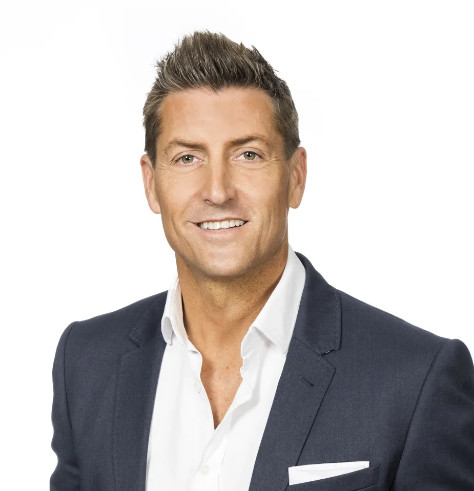 Professional man in a suit smiling, possibly for Elementor Single Post.