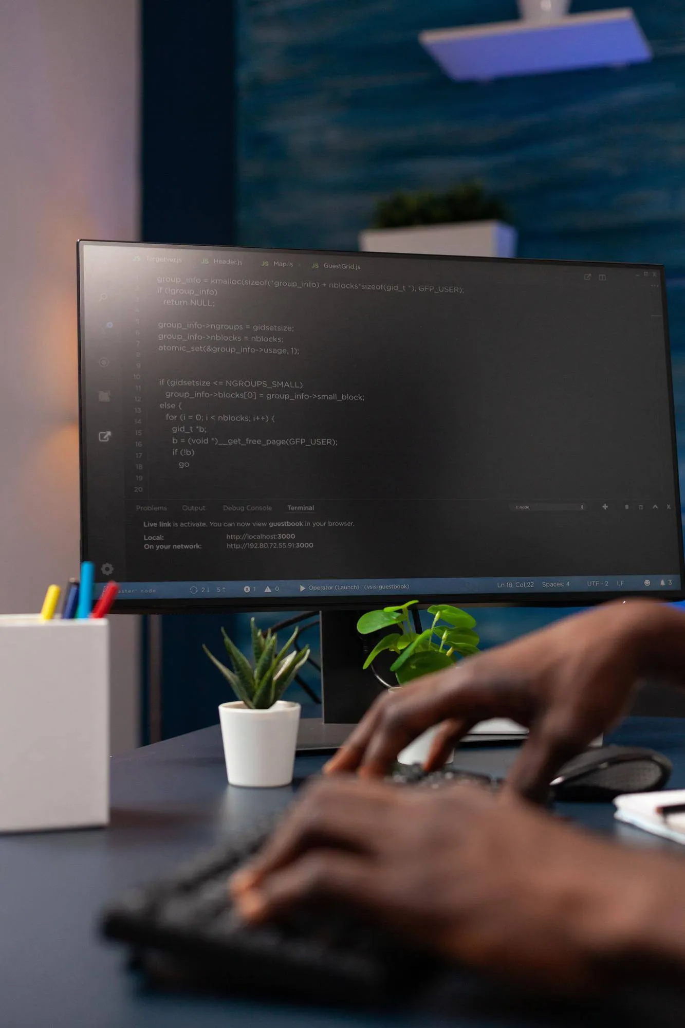 Developer coding on a monitor with JavaScript. Law firm content marketing.