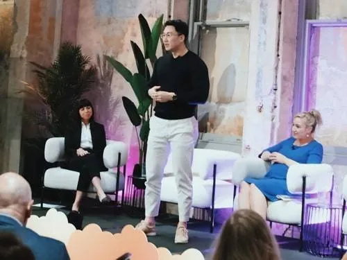 Panel discussion with three speakers on stage at a home event